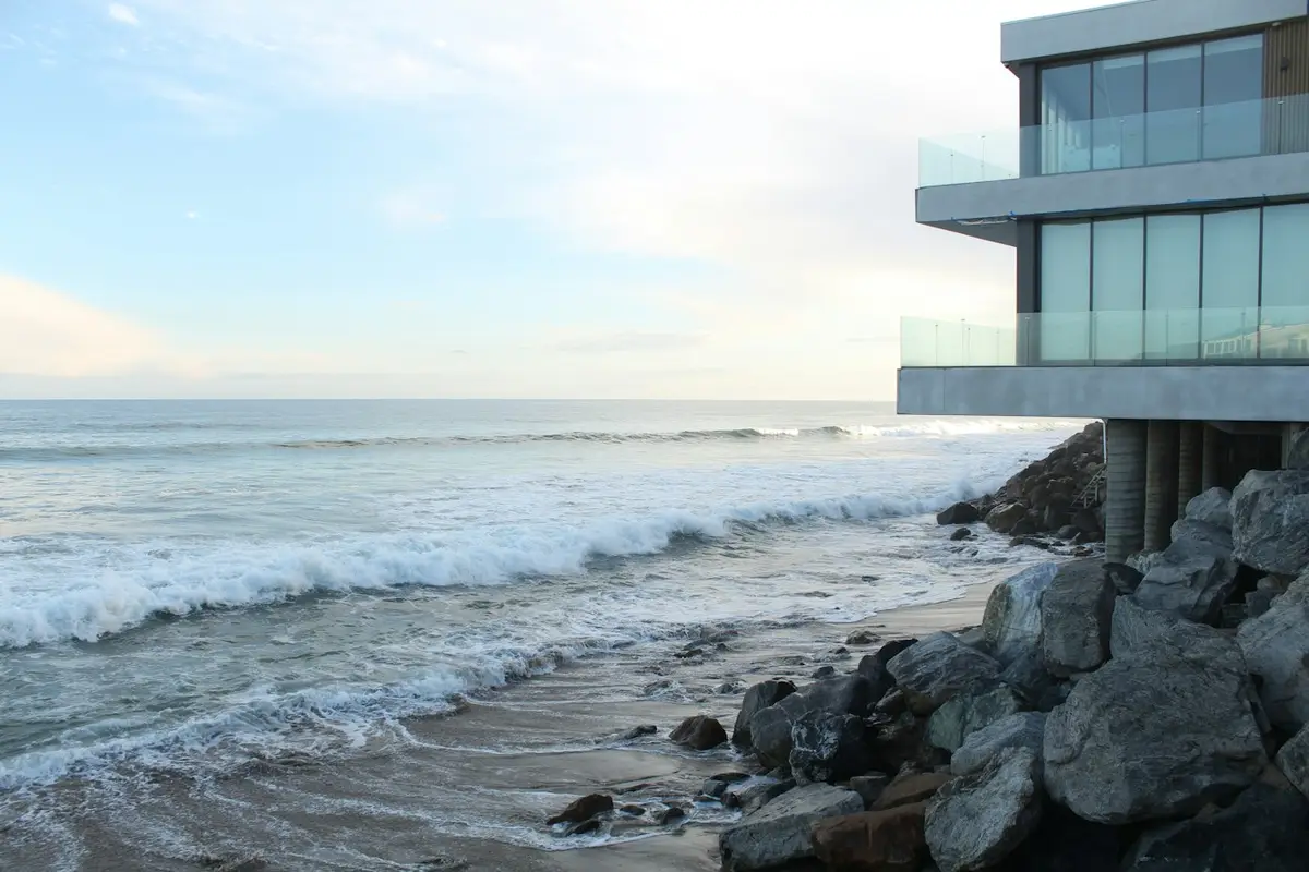 Coastal home with large windows facing the water